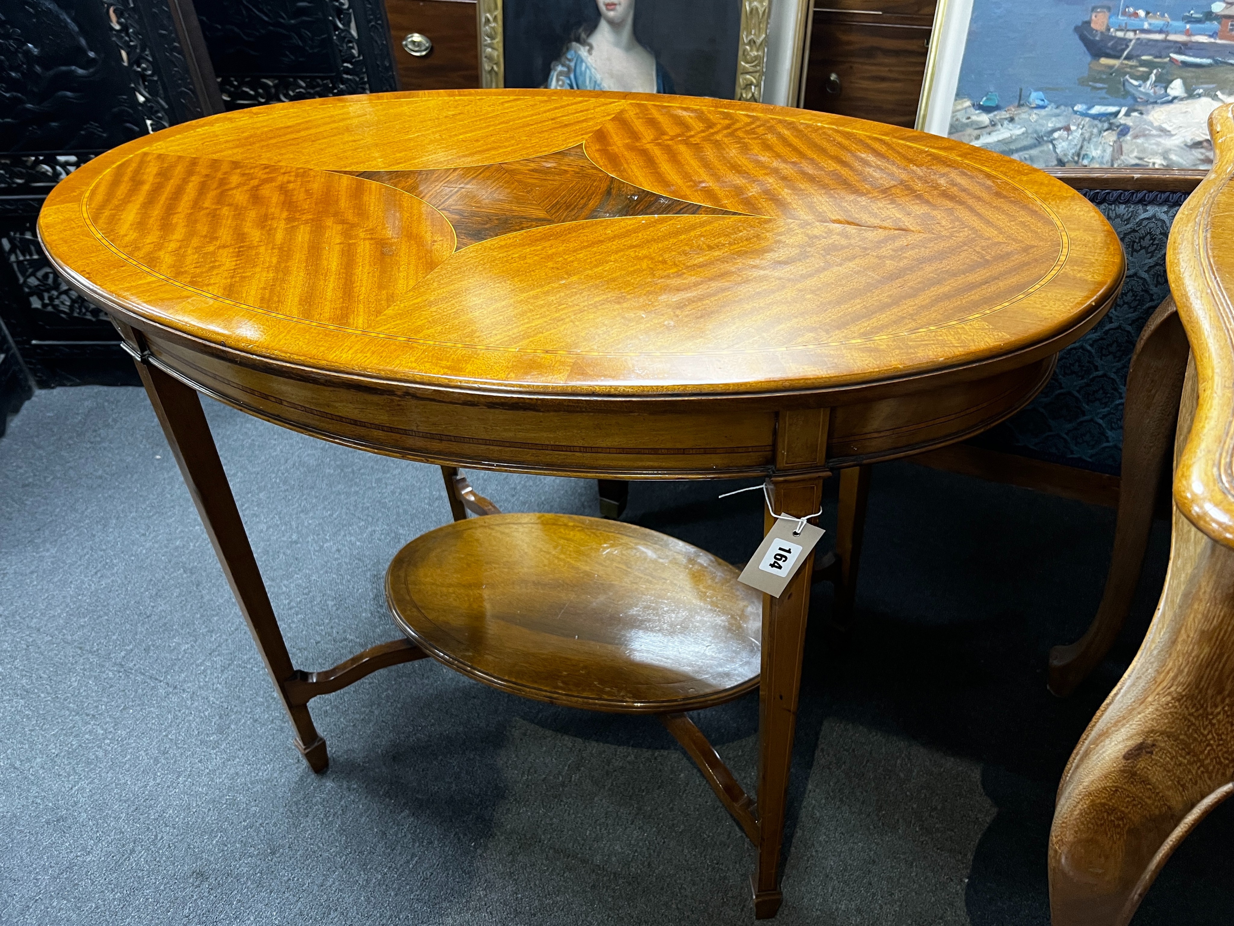 An Edwardian satinwood banded oval satinwood two tier centre table, width 98cm, depth 60cm, height 73cm